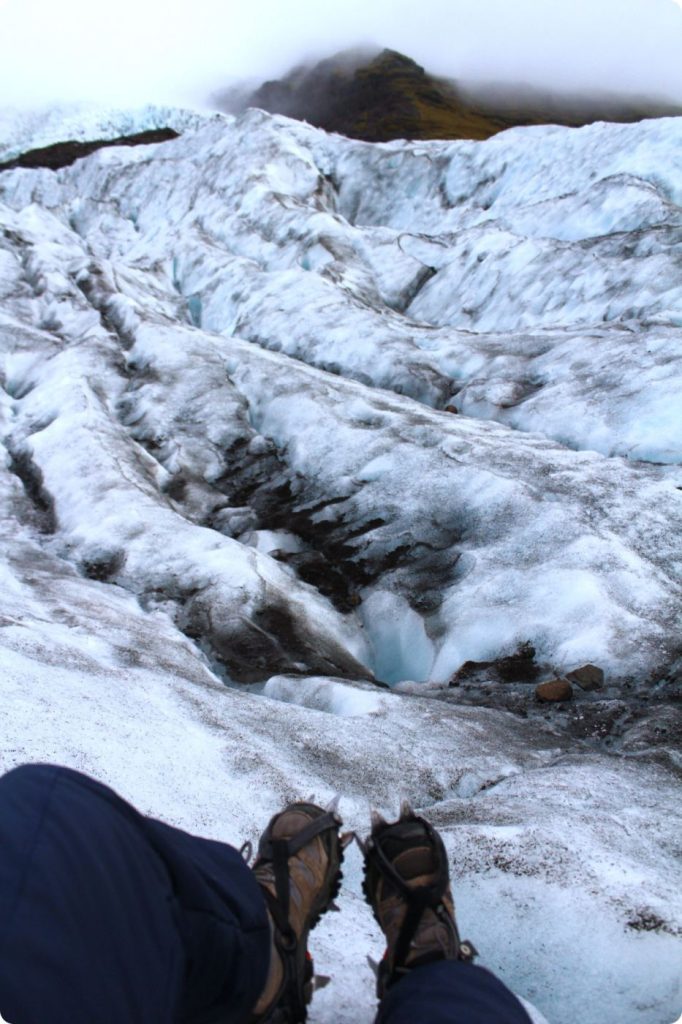 Crampons on glacier ice during a hike in Iceland.